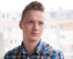 man-standing-at-balcony-PBFGRDZ-300x246