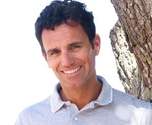smiling-middle-aged-man-standing-outdoors-PTRPK6H-300x246